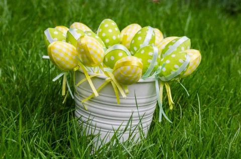 Easter eggs in white pail on grass Stock Photos