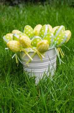 Easter eggs in white pail on grass 스톡 사진