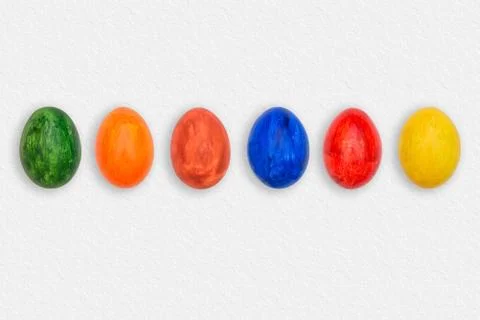 Easter eggs on white paper. Multicolored eggs on a paper background. A set of Stock Photos