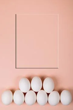 Easter eggs white on a pink background with place for text. Stock Photos