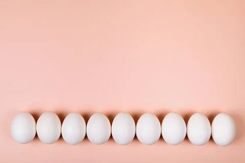 Easter eggs white on a pink background with place for text. Stock Photos