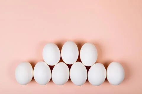 Easter eggs white on a pink background with place for text. Stock Photos