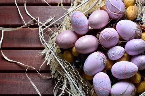 Easter eggs in a white wire basket Stock Photos