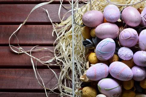 Easter eggs in a white wire basket Stock Photos