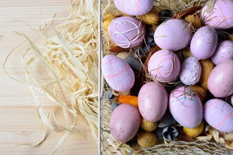 Easter eggs in a white wire basket Stock Photos