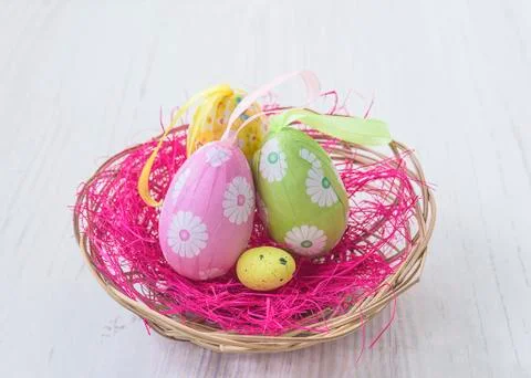 Easter eggs in wicker basket. Close up Stock Photos