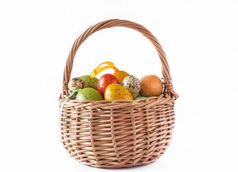 Easter eggs in wicker basket isolated on white background Stock Photos