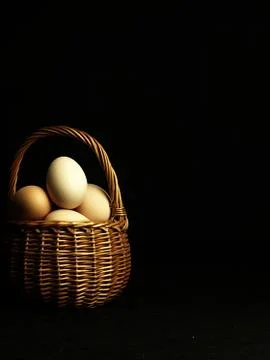 Easter eggs in a wicker basket. Stock Photos