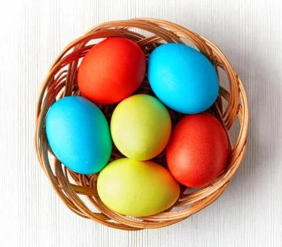 Easter eggs in a wicker basket Stock Photos