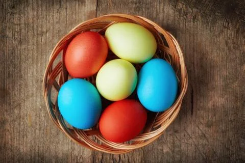 Easter eggs in a wicker basket Stock Photos