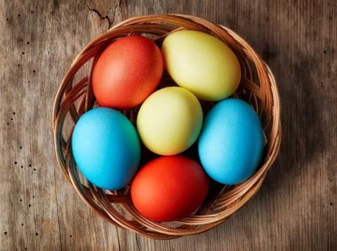 Easter eggs in a wicker basket Stock Photos