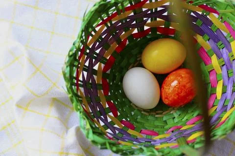 Easter eggs in a wicker basket Stock Photos