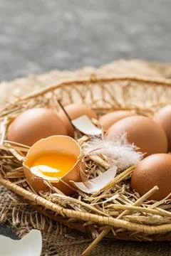 Easter eggs  in a Wicker basket with straw. Stock Photos