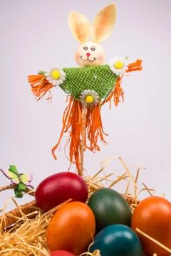 Easter eggs in wicker basket on white Stock Photos