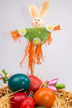 Easter eggs in wicker basket on white Stock Photos