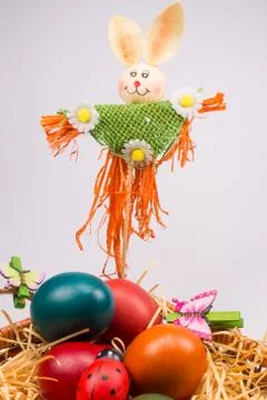 Easter eggs in wicker basket on white Stock Photos