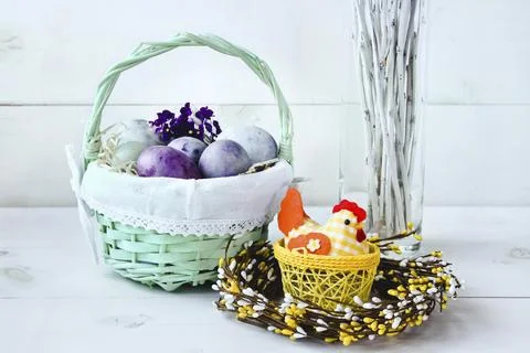 Easter eggs in a wicker basket on a white background Stock Photos