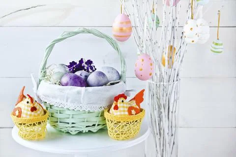 Easter eggs in a wicker basket on a white background. Decorative chicken Stock Photos
