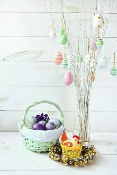 Easter eggs in a wicker basket on a white background. Decorative chicken Stock Photos