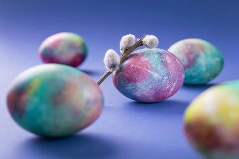Easter eggs with willow branches on a trend violet Stock Photos