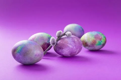 Easter eggs with willow branches on a trend violet Stock Photos