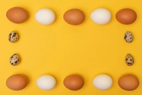 Easter eggs on a yellow background, place for an inscription in the center Stock Photos