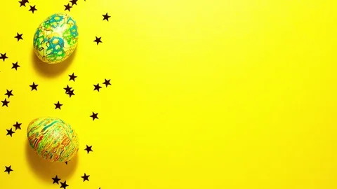 Easter eggs on yellow with copy space Stock Footage 123808737