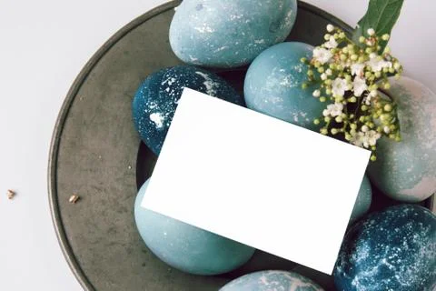 Easter empty greeting card on blue painted eggs Stock Photos