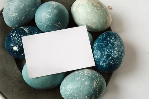Easter empty greeting card on blue painted eggs Stock Photos
