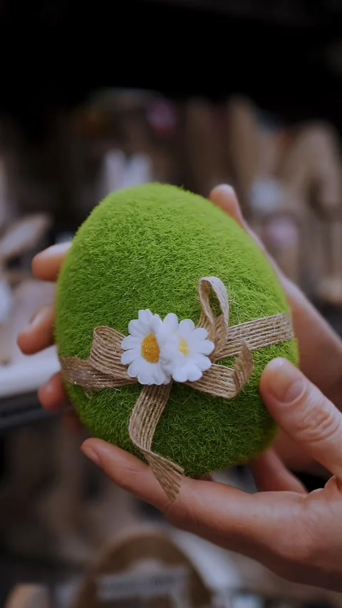 Easter fair. close-up. female hands holding a figurine of a funny green Easter Video stock 315218298