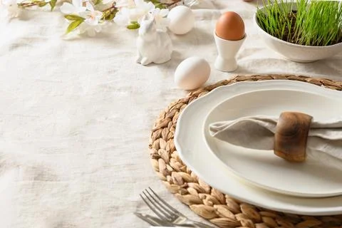 Easter festive dinner with egg, bunny, fresh flowers. Stock Photos