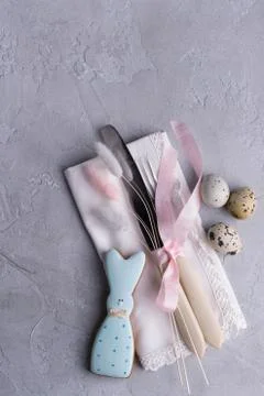 Easter  festive table setting with Easter bunny cookies, quail eggs. Stock Photos
