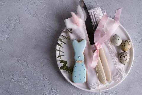 Easter  festive table setting with Easter bunny cookies, quail eggs. Stock Photos