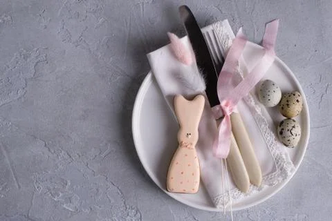 Easter  festive table setting with Easter bunny cookies, quail eggs. Stock Photos
