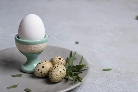 Easter  festive table setting with  gray plate, quail eggs  and chicken egg Stock Photos