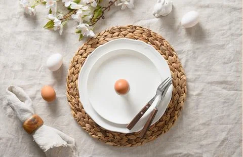 Easter festive table setting with organic brown egg, bunny and blossom flower Fotos Stock