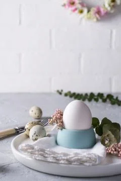 Easter  festive table setting with  quail eggs  and chicken egg, green  leaf Stock Photos