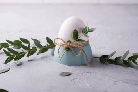 Easter  festive table setting with white chicken  eggs in eggs cups, leaf Fotos de archivo