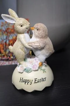 Easter figurine with dancing rabbit and chicken on a wooden table and the i.. Stock Photos