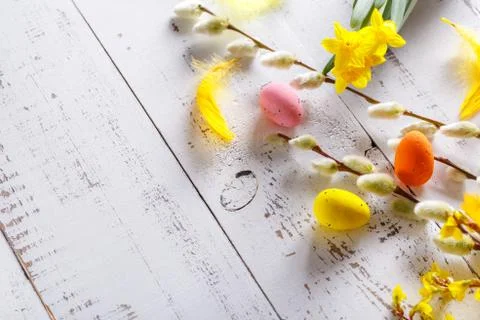 Easter flat lay background with spring flower, willow and easter eggs. Stock Photos