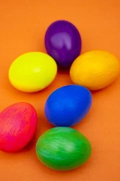 Easter Flat Lay with Multicolor Eggs in Rustic Bowl Isolated On Orange Stock Photos
