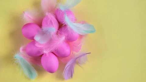 Easter Flat Lay. Pink and mint with a pink egg on a yellow background 스톡 동영상 329310096