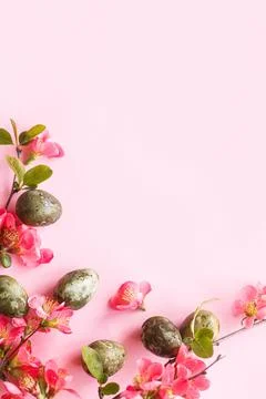 Easter flat lay. Stylish easter eggs and red flowers on pink background. Ea.. Stock Photos