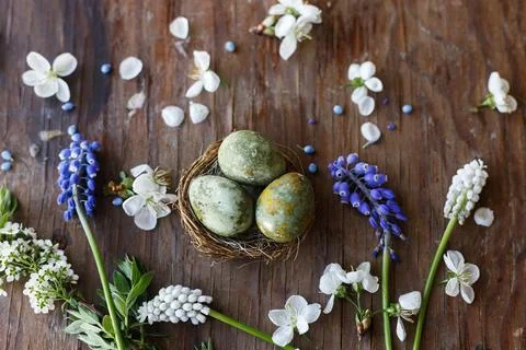 Easter flat lay. Stylish easter eggs in nest and flowers and cherry blossom.. Stockfoto's