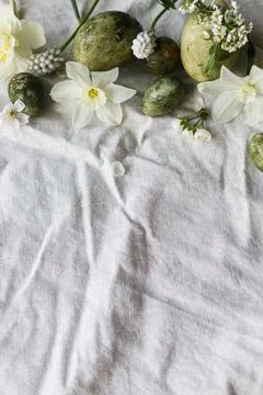 Easter flat lay. Stylish easter eggs, daffodils flowers and cherry blossoms.. Stock Photos