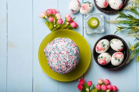 Easter flatlay composition with decorated eggs, flowers, burning candle 스톡 사진