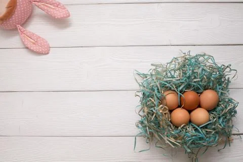 Easter flatlay with easter bunny toy and eggs on white wooden boards Stock Photos