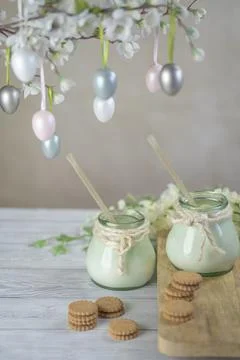 Easter flower biscuits and milk with Easter holiday decoration. Stock Photos