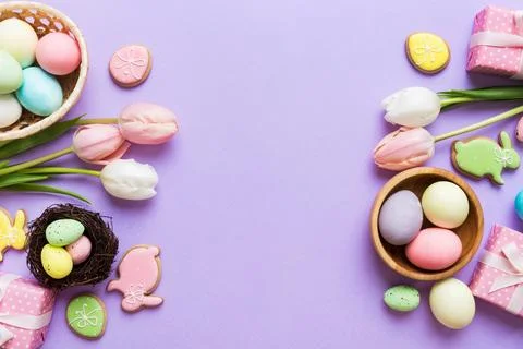 Easter frame with eggs, gift box and tulip on a colored background. The min.. 写真素材