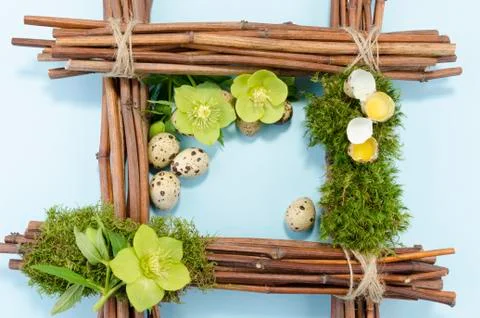 Easter frame with one boiled quail egg in the right corner and two raw plus t Stock Photos